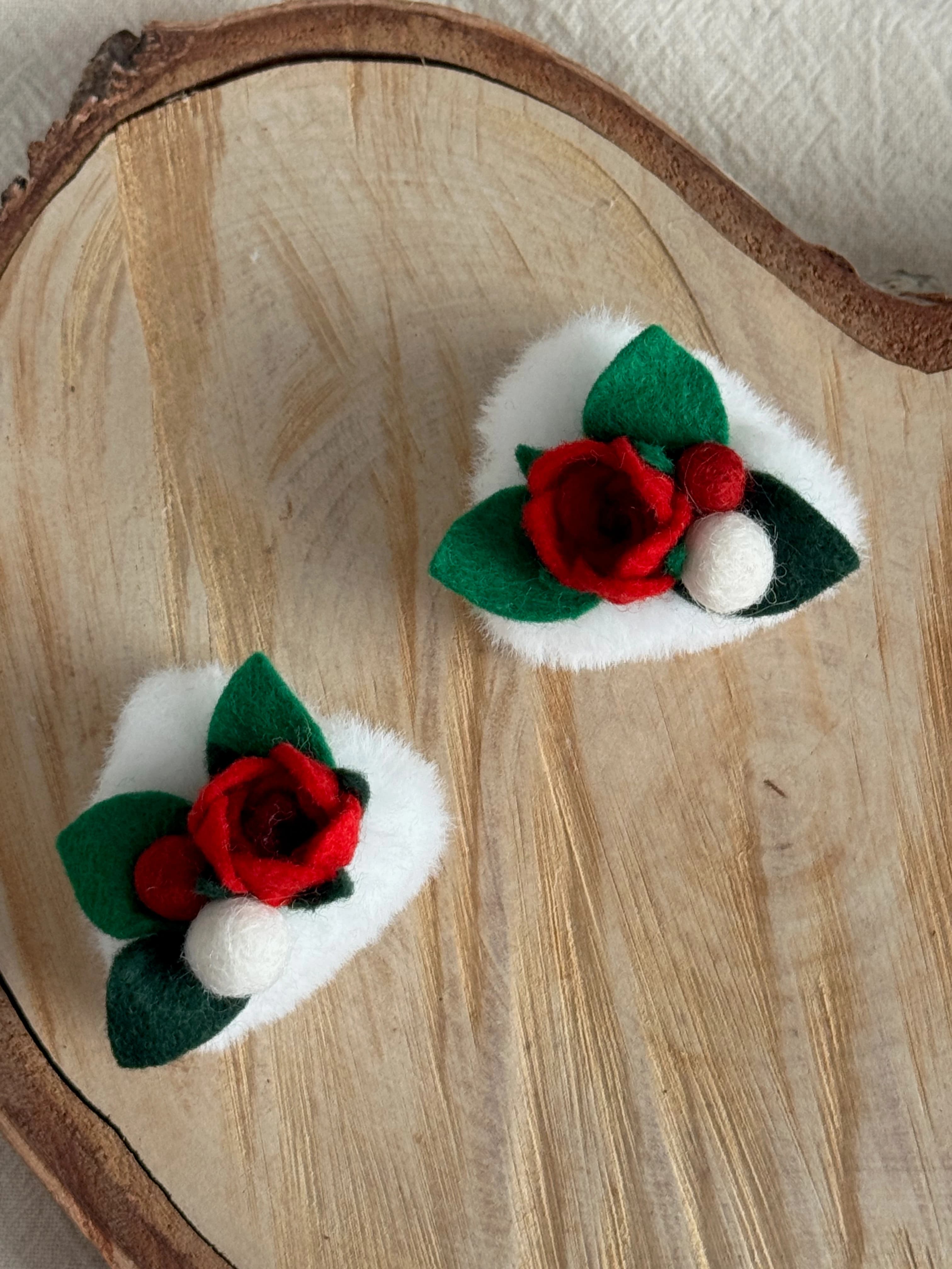 White and red rose cat-ear clips viewed from above
