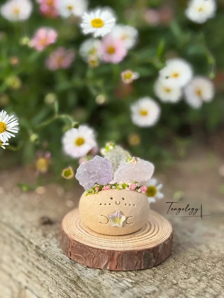 A Crysprout crowned with rough rose and lavender quartz