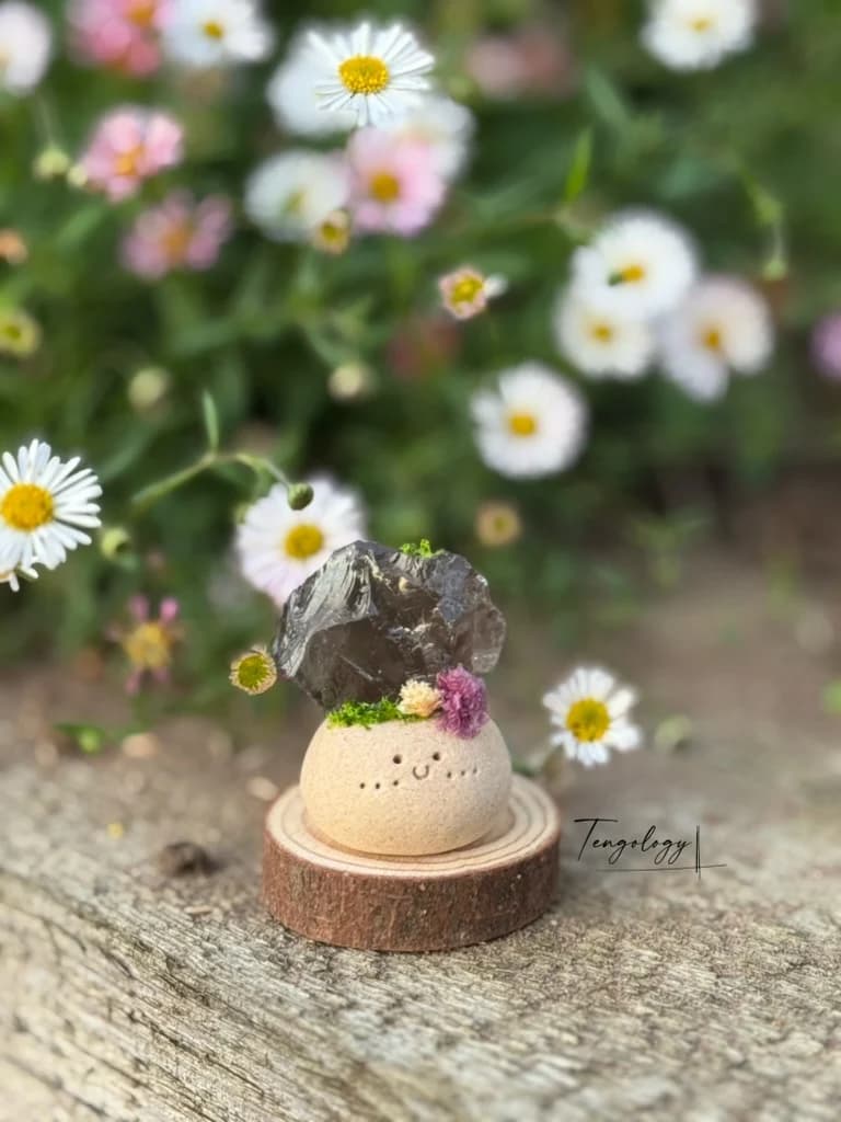 A small Crysprout with smoky quartz and lilac dried flowers