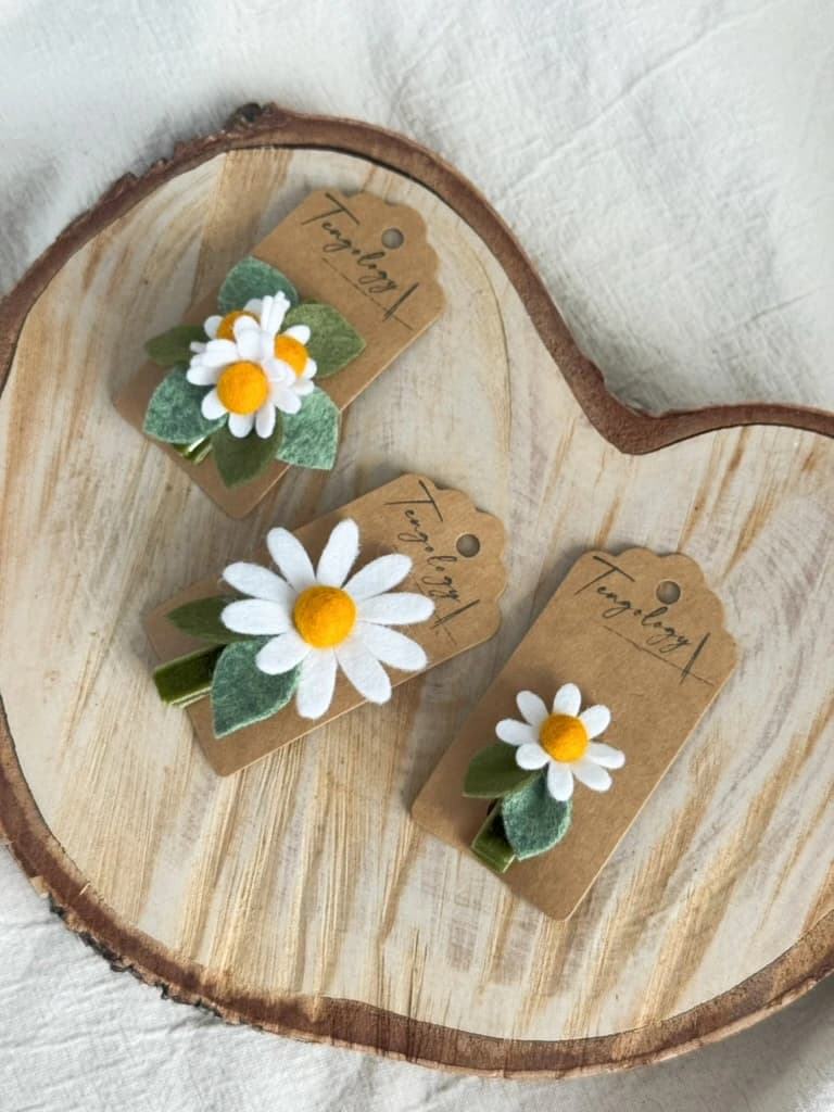 Daisy Hair Clip collection on a wooden tray