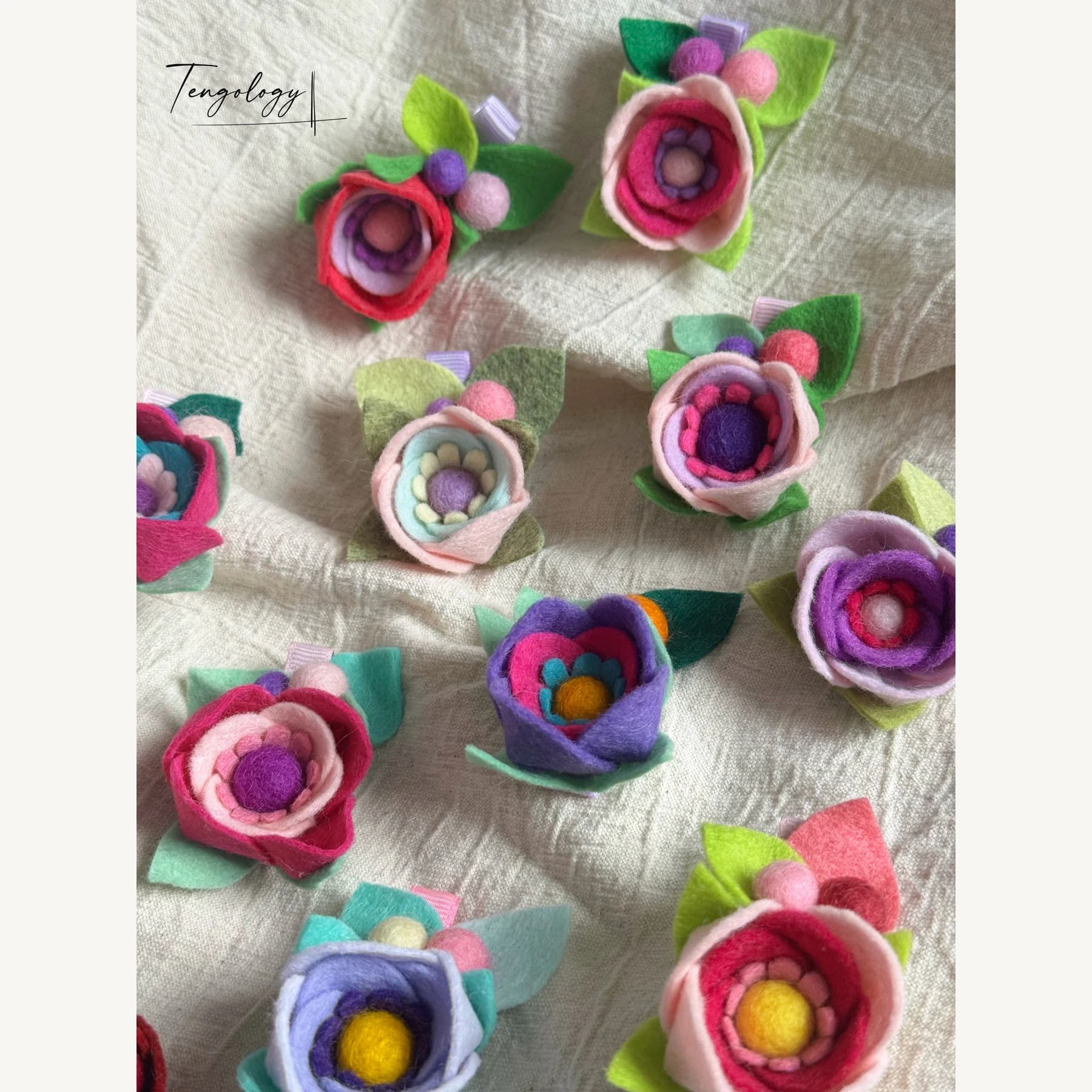 Layered felt flower hair clips — colourways together