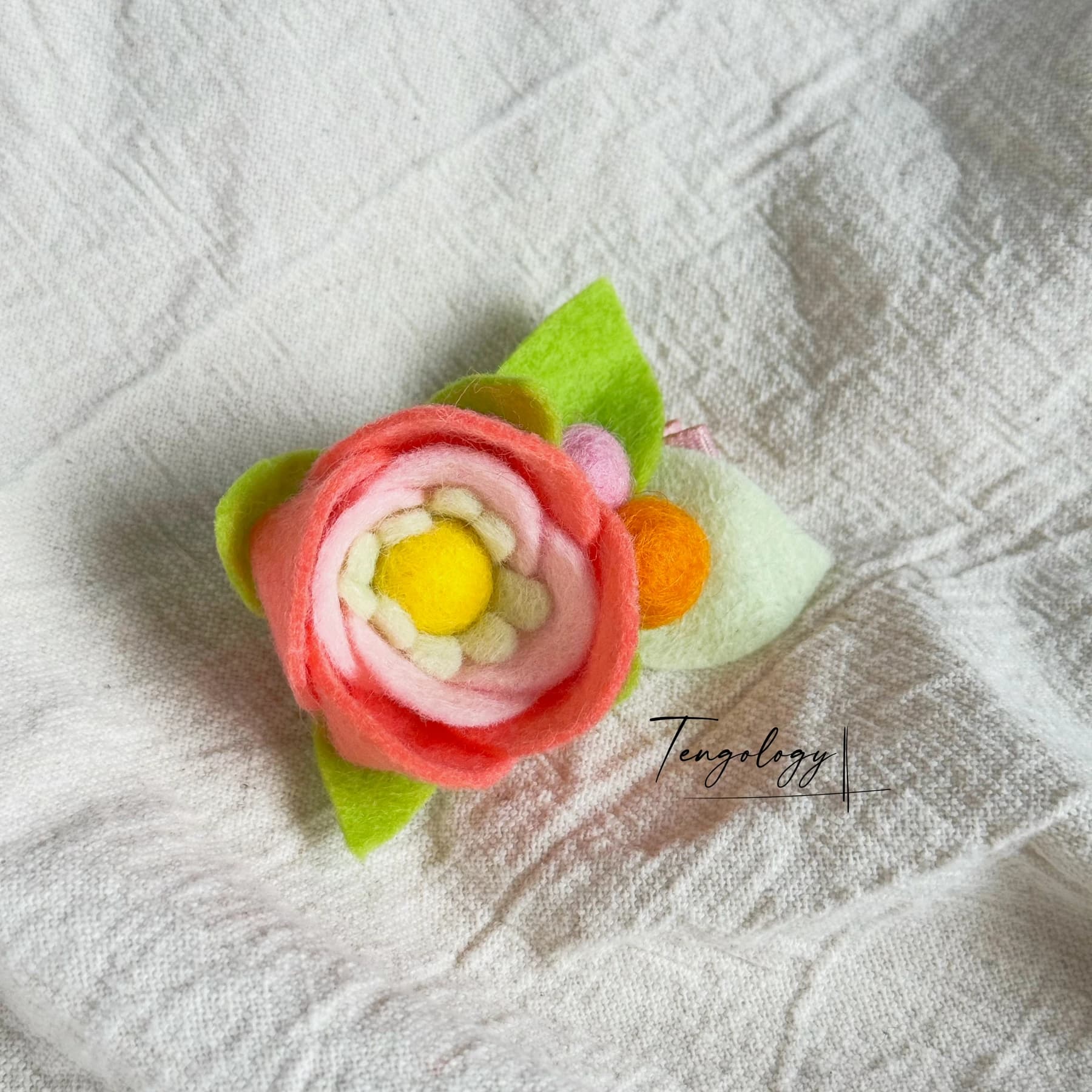 Layered felt flower hair clip — Coral / yellow centre, front