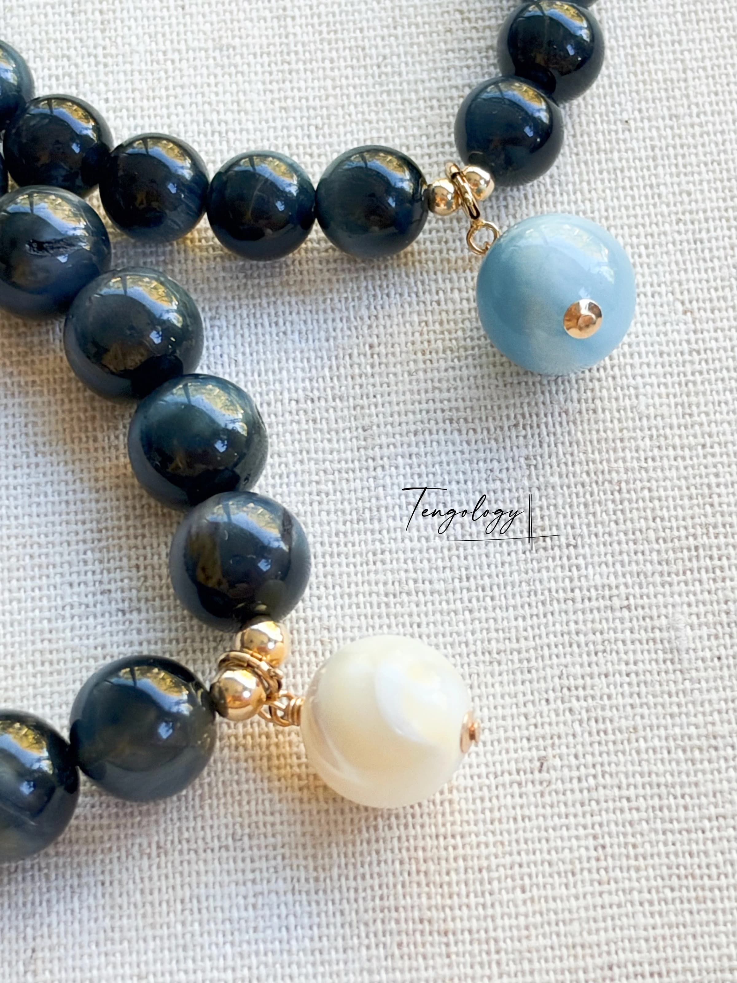 Pair with intention — Orbit — Blue Tiger’s Eye pairing example. Bracelets and charms sold separately.