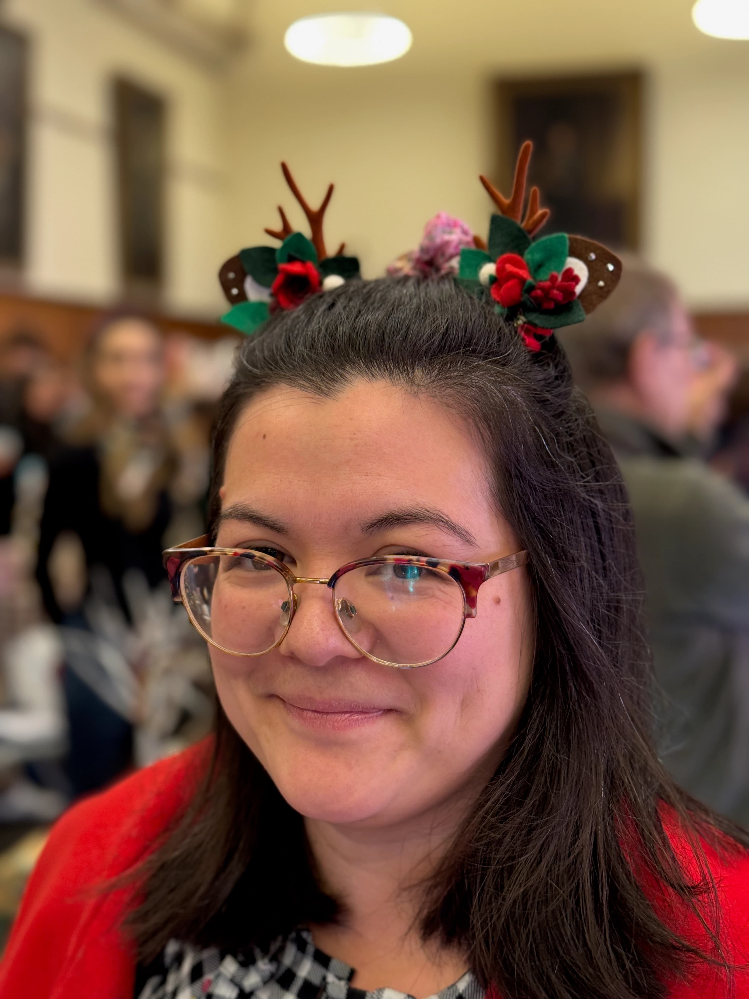 Red reindeer antler and rose hair clips — pair worn by a customer