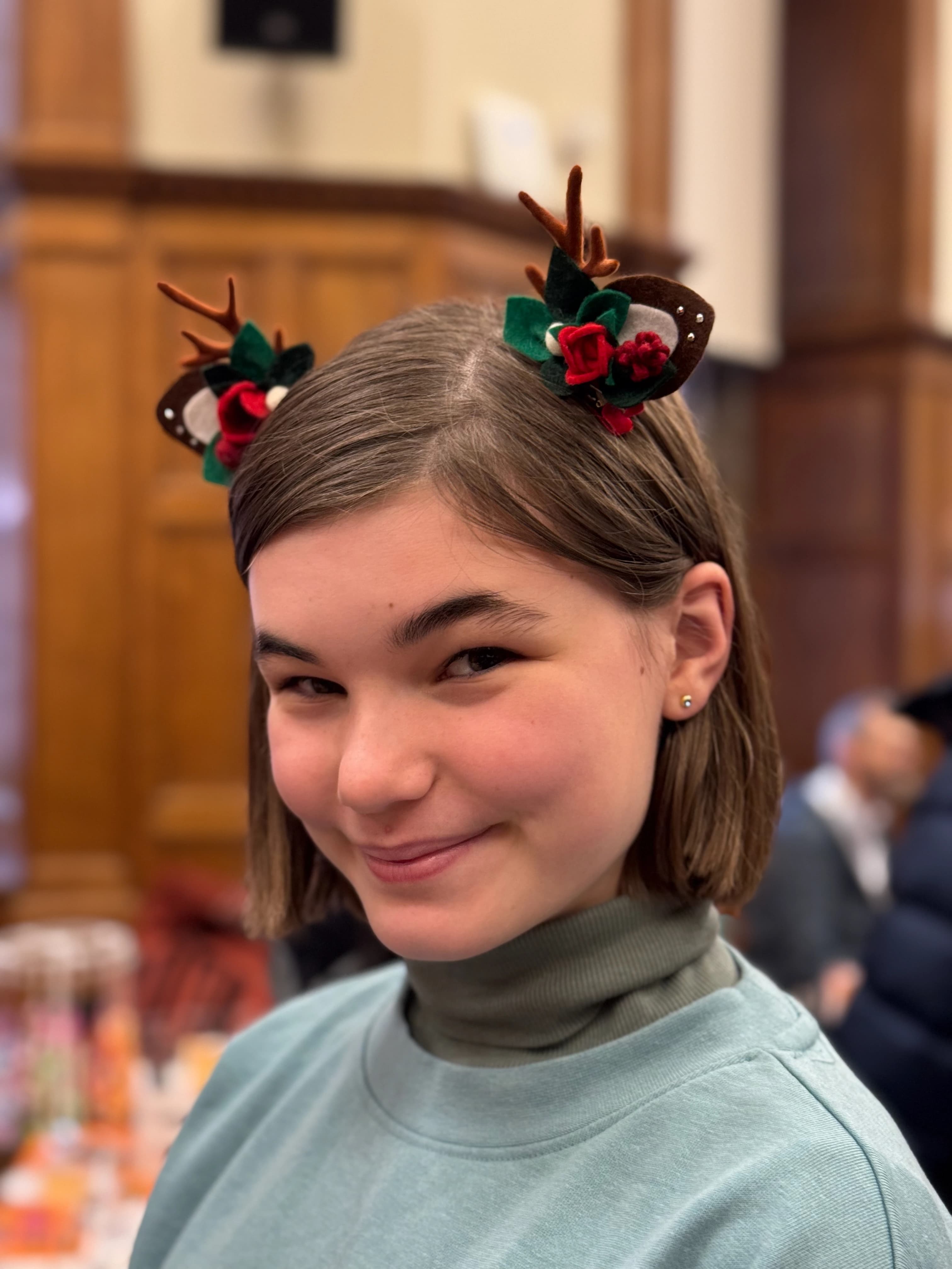 Red reindeer antler and rose hair clips — pair worn by a customer