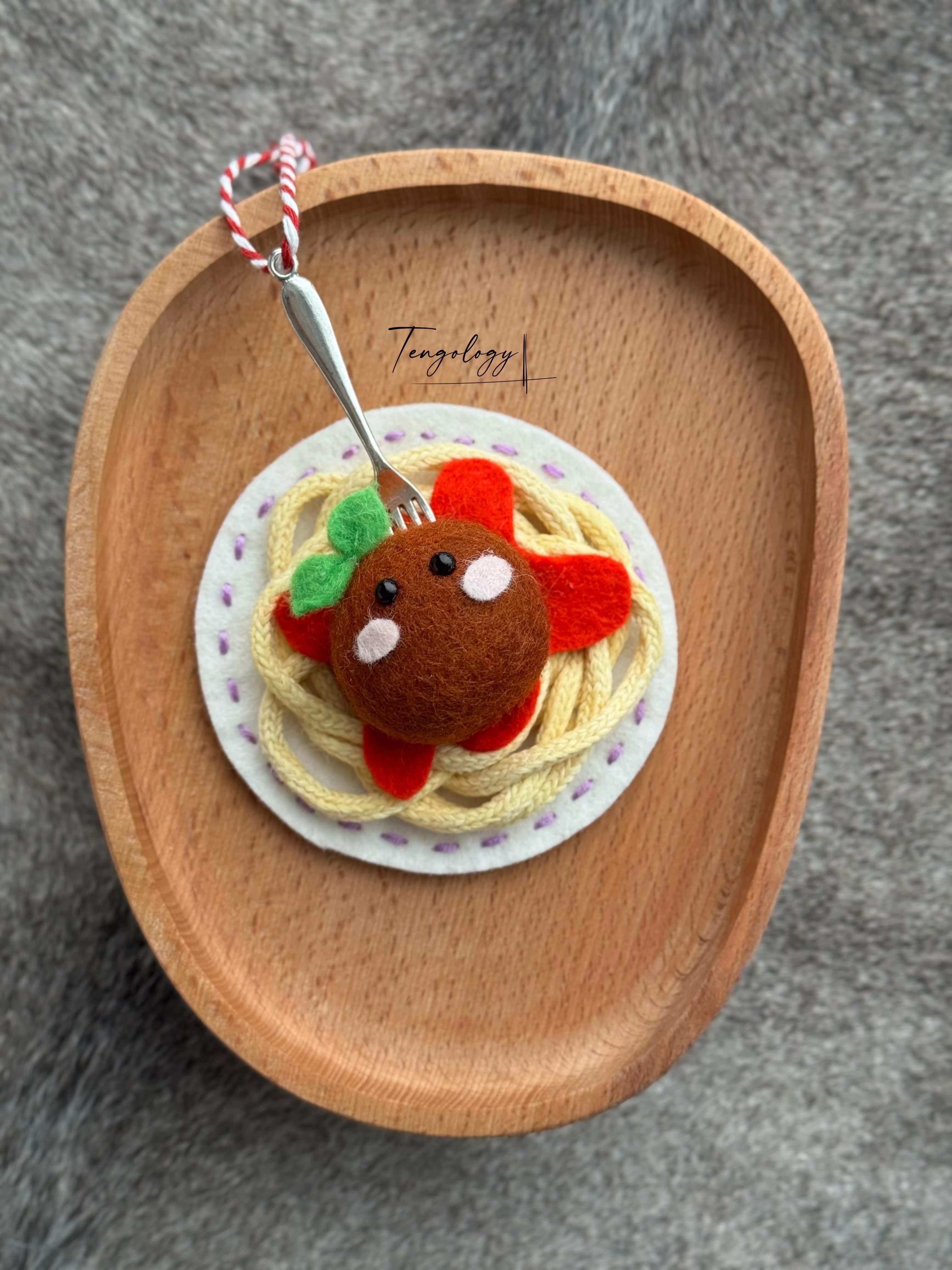 Spaghetti and meatball felt ornament with lavender stitching around the plate