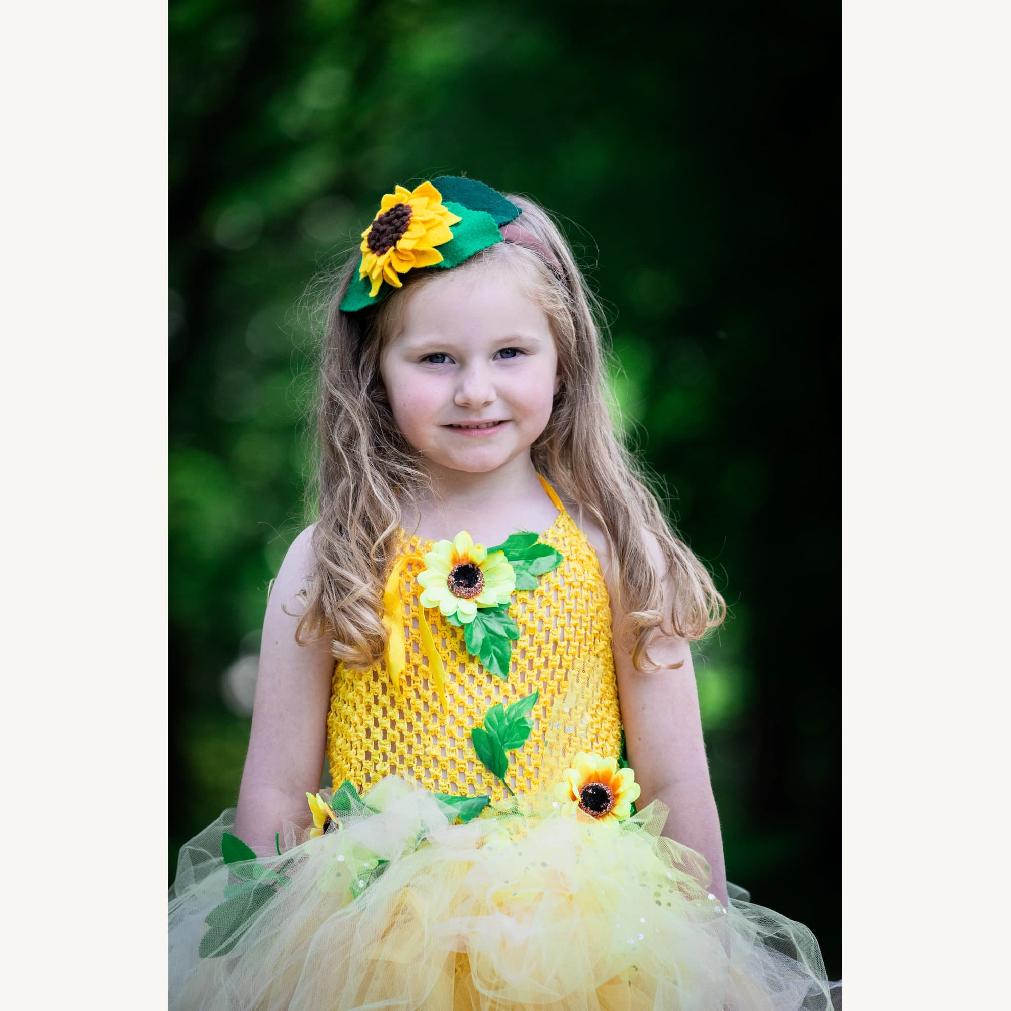 Sunflower felt headband worn by a model in a yellow dress