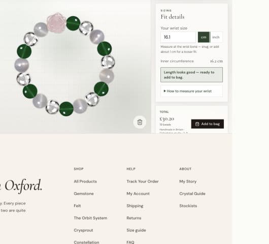 A custom bracelet in the design workspace, combining green agate, clear quartz, milky beads and a pink rose-shaped focal bead